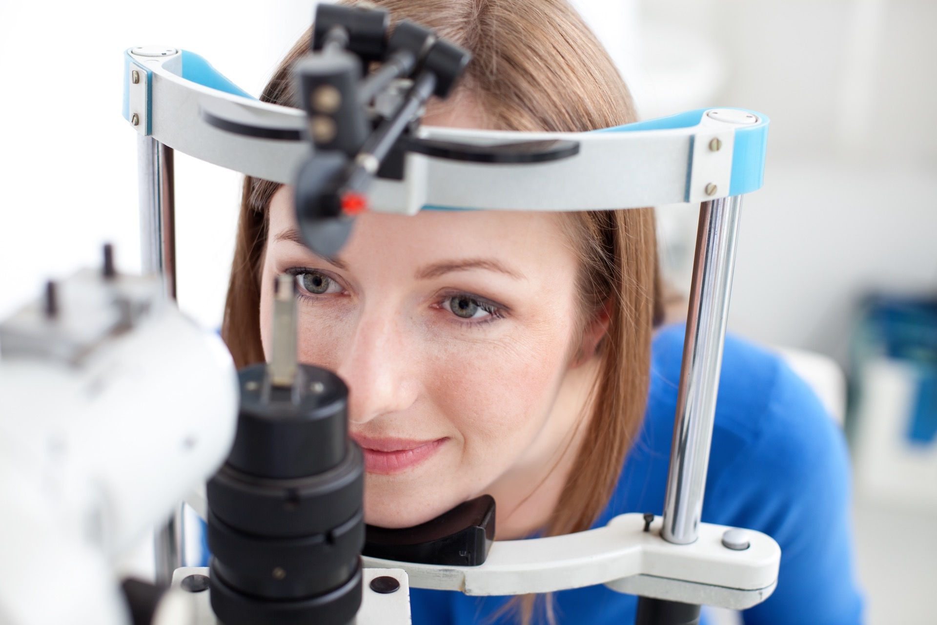 Young woman is having eye exam performed by eye doctor